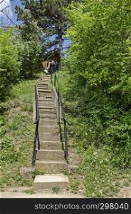 Wooden hit with staircase in springtime forest, resort village Pancharevo, Lozen mountain, Sofia, Bulgaria