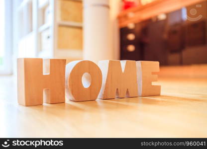 Wooden HOME Letters on the floor of an apartment