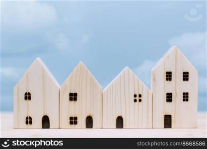 wooden home small model with blue sky for village good house city urban community concept.