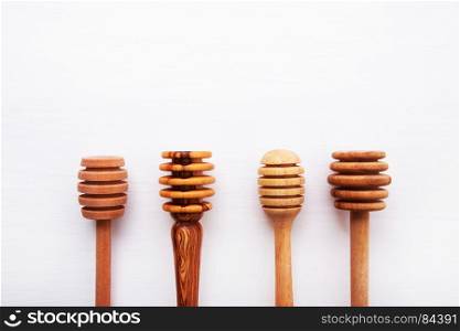 wooden honey stick isolated on white wooden background, Top view with copy space.