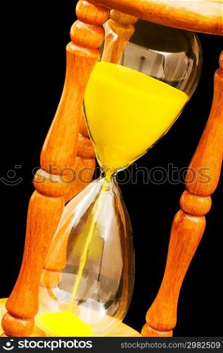 Wooden hourglass isolated on the black background
