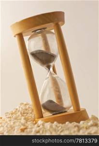 Wooden Hourglass with black sand over white sand