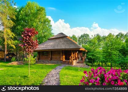 Wooden house and meadow at the sunrise. Meadow at sunrise