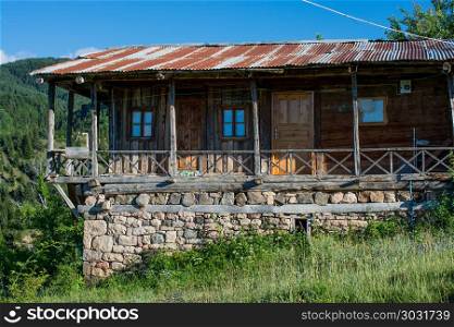 Wooden house in the country . Wooden house in green in the country in Turkey