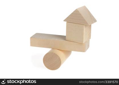 Wooden house on abstract scales. It is isolated on a white background
