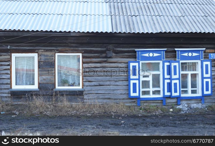 wooden house with plastic and wooden windows