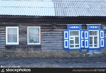 wooden house with plastic and wooden windows