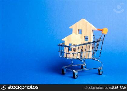 Wooden houses in a trading cart. The concept of buying a house or apartment. Affordable housing. Profitable and cheap loans for real estate. Buying a home. Mortgage and loan. Place for text
