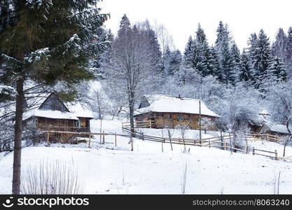 Wooden houses in forest covered with snow in winter. Wooden houses in forest covered with snow