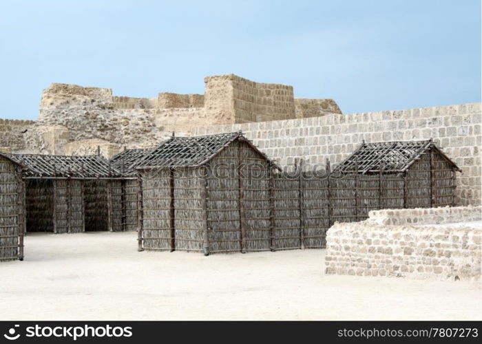 Wooden houses inside fort Bahrein near Manama city