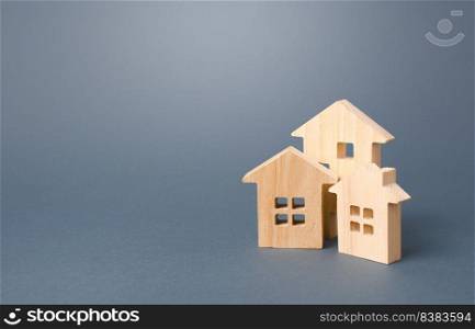 Wooden houses on a gray background. Buy purchase and sale of housing, rental. Community owners of apartments and houses. Construction industry, maintenance and utilities. Mortgage loan real estate