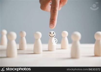 Wooden human figure held by man hand. HR officer looks for leader and CEO. Leader steps out of crowd. Personal development, motivation, challenge. HR, HRM, HRD concepts. Human Resource Management.