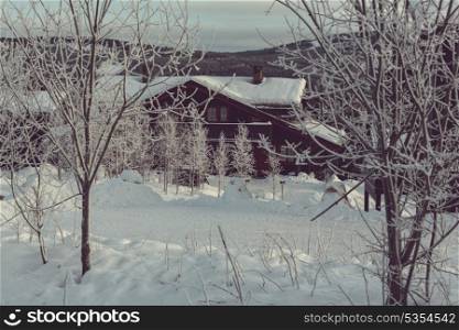 wooden hut in the mountains at winter
