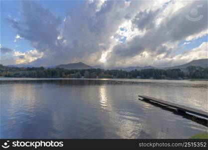 Wooden jetty into the lake with clouds above at Lake Naverone Drakensberg South Africa