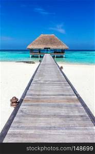 Wooden jetty leading to relaxation lodge. Maldives islands resort on Indian Ocean. Wooden jetty leading to relaxation lodge. Maldives islands
