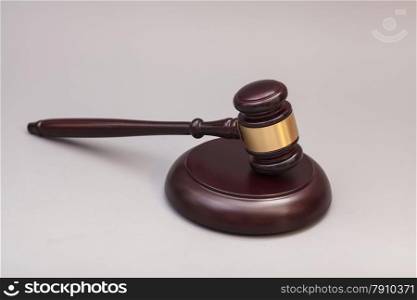 Wooden judge gavel and soundboard isolated on gray background