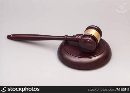 wooden judge gavel and soundboard on grey background