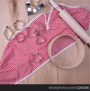 wooden kitchen items on a red towel, top view