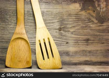 Wooden kitchen spoon on wooden background