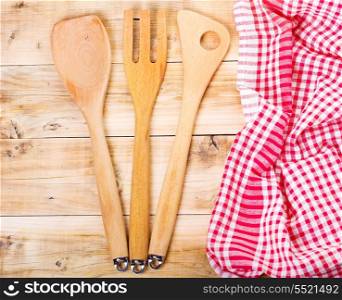 wooden kitchen utensils lying on wooden table