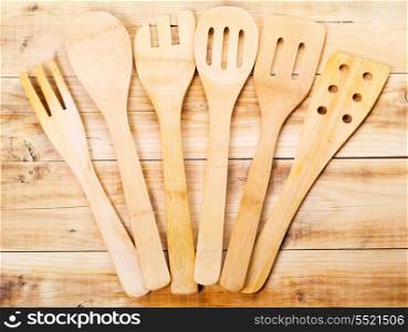 wooden kitchen utensils lying on wooden table