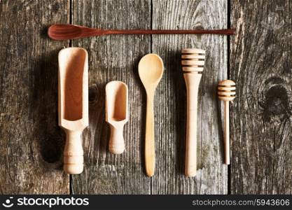 Wooden kitchen utensils on old wooden background
