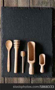 Wooden kitchen utensils on slate