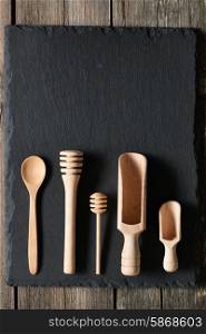 Wooden kitchen utensils on slate