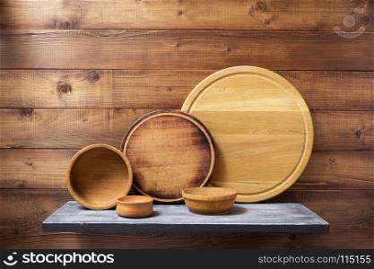 wooden kitchenware at shelf on brown background