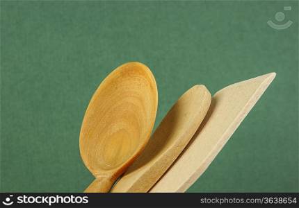 wooden kitchenware on the green background