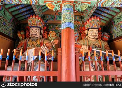 Wooden Korean Guardian Sculptures before entrance in Beomeosa Temple