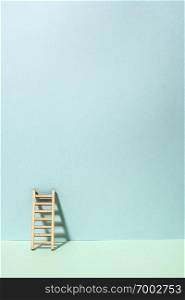 Wooden ladder on wall. Pastel tones. Concept for success and growth. Business metaphors.