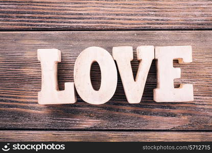 Wooden letters LOVE on a wooden background