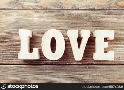 Wooden letters LOVE on a wooden background. The Wooden LOVE
