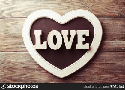Wooden letters LOVE on heart shape chalkboard. Wooden letters LOVE