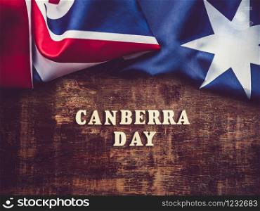 Wooden letters of the alphabet in the form of the words CANBERRA DAY lying on the table. Beautiful card. Isolated background, wooden surface. Congratulations for relatives, friends and colleagues. Beautiful, bright card. Isolated background, close up