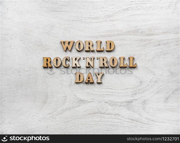 Wooden letters of the alphabet in the form of the words ROCK &rsquo;N&rsquo; ROLL DAY lying on the table. Beautiful card. Isolated background, wooden surface. Congratulations for relatives, friends and colleagues. Happy ROCK &rsquo;N&rsquo; ROLL DAY. Beautiful card.