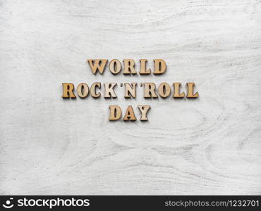 Wooden letters of the alphabet in the form of the words ROCK &rsquo;N&rsquo; ROLL DAY lying on the table. Beautiful card. Isolated background, wooden surface. Congratulations for relatives, friends and colleagues. Happy ROCK &rsquo;N&rsquo; ROLL DAY. Beautiful card.