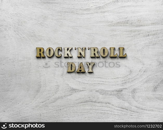 Wooden letters of the alphabet in the form of the words ROCK &rsquo;N&rsquo; ROLL DAY lying on the table. Beautiful card. Isolated background, wooden surface. Congratulations for relatives, friends and colleagues. Happy ROCK &rsquo;N&rsquo; ROLL DAY. Beautiful card.