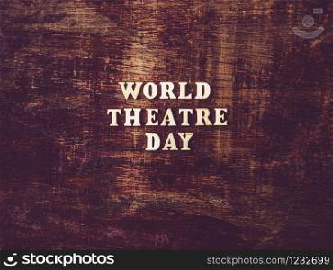 Wooden letters of the alphabet in the form of the words THEATRE DAY lying on the table. Beautiful card. Isolated background, wooden surface. Congratulations for relatives, friends and colleagues. Happy THEATRE DAY. Beautiful greeting card. Isolated background