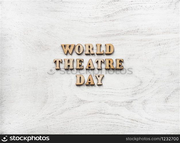 Wooden letters of the alphabet in the form of the words THEATRE DAY lying on the table. Beautiful card. Isolated background, wooden surface. Congratulations for relatives, friends and colleagues. Happy THEATRE DAY. Beautiful greeting card. Isolated background