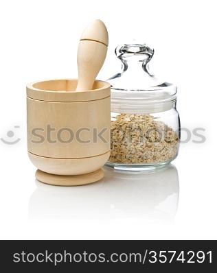 Wooden mortar and muesli in glass jar