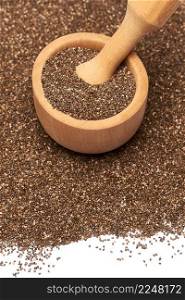 Wooden mortar full of organic natural chia seeds and pestel close-up. High quality photo. Wooden mortar full of organic natural chia seeds and pestel close-up