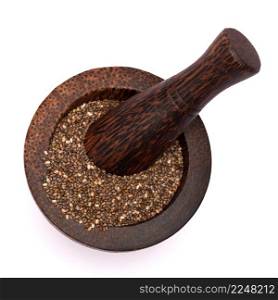 Wooden mortar full of organic natural chia seeds and pestle close-up isolated. High quality photo. Wooden mortar full of organic natural chia seeds and pestle close-up isolated