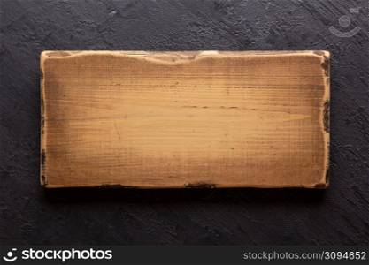 Wooden nameplate or sign board on wall background. Front view of name plate