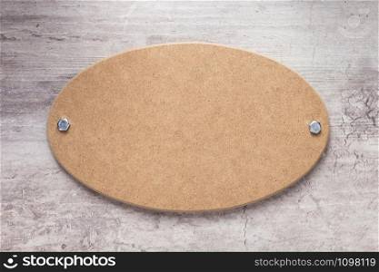 wooden nameplate or wall sign at concrete background texture surface, with screws
