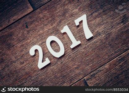 Wooden numbers forming the number 2017, For the new year 2017 on a rustic wooden background.