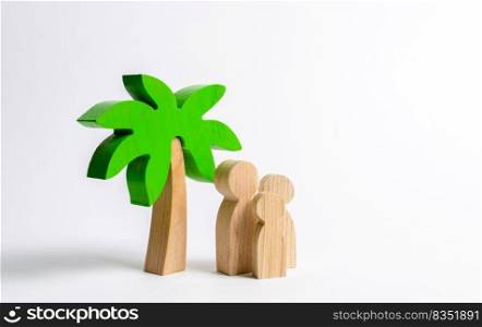 Wooden palm tree and family. Family holidays with children. Tours and cruises to warm countries. The development of tourism. Tropical island. Conceptual leisure and vacation, entertainment