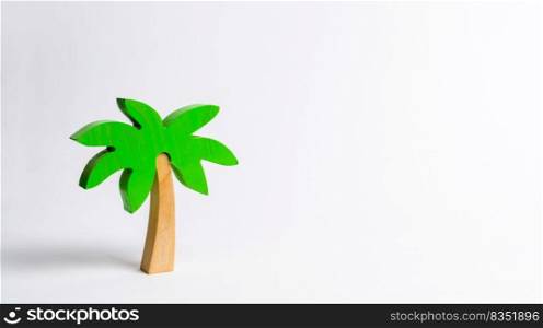 Wooden palm tree on a white background. Conceptual leisure and vacation, entertainment and relaxation. Tours and cruises to warm countries. The development of tourism. Tropical island.