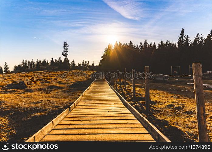 Wooden path at the top of schockl mountain in Graz Austria leading to view point. Sunset landscape. Wooden path at the top of schockl mountain in Graz Austria leading to view point